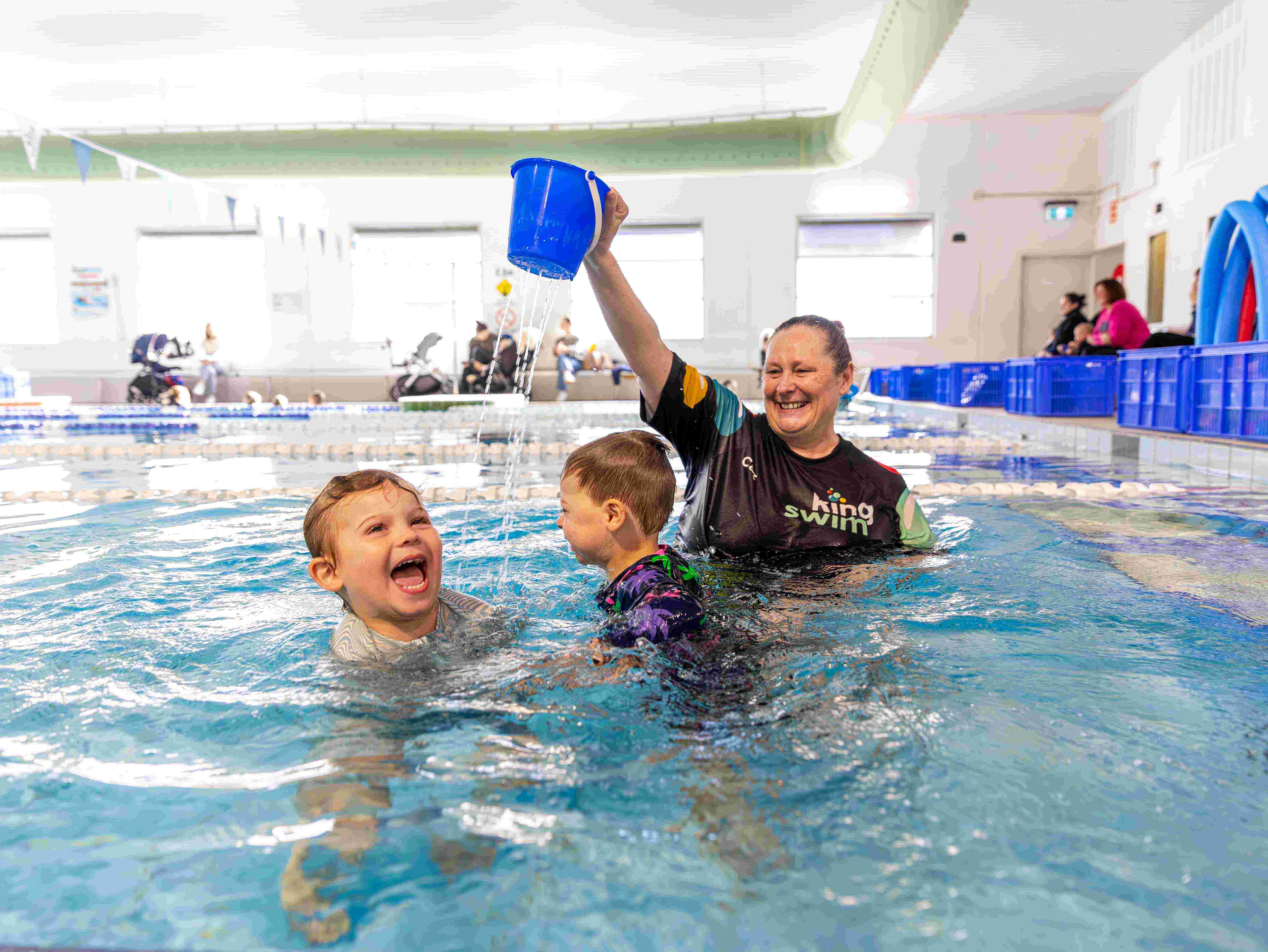 Two children having fun in the pool during a Kingswim lesson